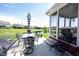Backyard patio with table and chairs and an umbrella overlooking the pond at 10267 Ranford Blvd, Fishers, IN 46040