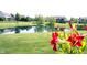 A picturesque backyard view with a serene pond reflecting the surrounding homes and lush greenery at 10267 Ranford Blvd, Fishers, IN 46040