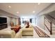 Spacious finished basement with a plush sofas, a coffee table, and a relaxing entertainment area at 10267 Ranford Blvd, Fishers, IN 46040