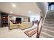 Finished basement with plush seating, a large television, and plenty of room for entertaining at 10267 Ranford Blvd, Fishers, IN 46040