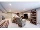 Open-concept basement with a plush seating area, a bookcase, and comfortable relaxation spaces at 10267 Ranford Blvd, Fishers, IN 46040