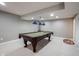 Finished basement with a billiard table and a three light pendant at 10267 Ranford Blvd, Fishers, IN 46040