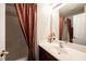 Bathroom featuring a single sink vanity, updated lighting fixtures, and a shower-tub combo at 10267 Ranford Blvd, Fishers, IN 46040