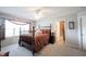 The primary bedroom features a decorative bed frame, plush carpet flooring, and great natural light at 10267 Ranford Blvd, Fishers, IN 46040