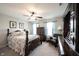 Spacious bedroom with a ceiling fan, cozy furniture, and a large window for natural light at 10267 Ranford Blvd, Fishers, IN 46040