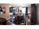 Dining room with hardwood floors, elegant table and chairs, and view to foyer at 10267 Ranford Blvd, Fishers, IN 46040