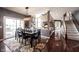 Inviting dining room with a dark wood table, seating for six, and a decorative rug and a view to the stairs at 10267 Ranford Blvd, Fishers, IN 46040