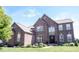 Beautiful two-story brick home featuring manicured lawn and landscaping at 10267 Ranford Blvd, Fishers, IN 46040
