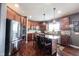 Spacious kitchen with dark wood cabinets, stainless steel appliances, hardwood floors, and a center island at 10267 Ranford Blvd, Fishers, IN 46040
