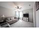 Bright living room features neutral tones, a ceiling fan, and comfortable seating with views of the backyard at 10267 Ranford Blvd, Fishers, IN 46040