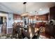 Spacious living area with kitchen, dining area, hardwood floors, and a large dark wood table at 10267 Ranford Blvd, Fishers, IN 46040