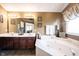 Main bathroom featuring a soaking tub, double vanity, decorative light fixtures and a glass shower at 10267 Ranford Blvd, Fishers, IN 46040