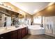 Bright main bathroom with soaking tub, walk-in shower, double vanity, and decorative accents at 10267 Ranford Blvd, Fishers, IN 46040