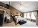 Inviting main bedroom showcasing a tray ceiling, accent wall, and a cozy seating area at 10267 Ranford Blvd, Fishers, IN 46040
