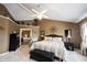 Comfortable main bedroom with tray ceiling, decorative accents, seating area, and ample natural light at 10267 Ranford Blvd, Fishers, IN 46040