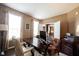 Well-lit office with a large desk, comfortable chairs, and view into the home at 10267 Ranford Blvd, Fishers, IN 46040