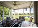 Enclosed patio with chairs and a ceiling fan that overlooks the pond at 10267 Ranford Blvd, Fishers, IN 46040