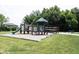 Outdoor playground with a slide, climbing structures, and a nearby bench nestled in green space at 10267 Ranford Blvd, Fishers, IN 46040