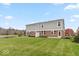 View of the home's backyard showing the lawn and exterior architecture at 10307 Gateway Dr, Brownsburg, IN 46234