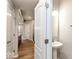 Well lit bathroom with pedestal sink next to doorway to living area at 10307 Gateway Dr, Brownsburg, IN 46234