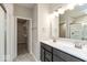 Bathroom featuring dual sinks, granite counters, and access to the walk-in closet at 10307 Gateway Dr, Brownsburg, IN 46234