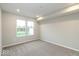 Spacious bedroom with neutral walls, plush carpet, and a view to the outside at 10307 Gateway Dr, Brownsburg, IN 46234