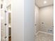 Hallway showing access to bathroom and laundry room with stylish flooring at 10307 Gateway Dr, Brownsburg, IN 46234
