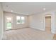Bright living room with neutral paint, plush carpet, and access to the outdoors at 10307 Gateway Dr, Brownsburg, IN 46234