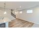 Open-concept living area with wood floors, a staircase, and multiple windows at 10307 Gateway Dr, Brownsburg, IN 46234