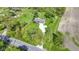 Aerial image featuring a home with green lawns, a shed, and an expansive gravel driveway at 10363 N County Road 950 E, Brownsburg, IN 46112