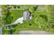 Aerial view of a home featuring a large backyard, gravel driveway, trees, and shed at 10363 N County Road 950 E, Brownsburg, IN 46112
