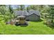 An aerial view showcases a home's backyard, complete with a deck, gazebo, and lush greenery at 10363 N County Road 950 E, Brownsburg, IN 46112
