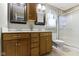 Functional bathroom with double sinks, tile floors, and a shower at 10363 N County Road 950 E, Brownsburg, IN 46112