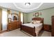 This is a spacious bedroom with carpeted floors, natural light, and a nice tray ceiling at 10363 N County Road 950 E, Brownsburg, IN 46112
