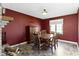 Dining room with a round table, wood floors, and red accent wall at 10363 N County Road 950 E, Brownsburg, IN 46112