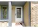 Close-up of the front door with a 'Hello' door mat and decorative trellis at 10363 N County Road 950 E, Brownsburg, IN 46112