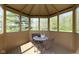 A charming screened-in gazebo has a small table and chairs, perfect for enjoying nature at 10363 N County Road 950 E, Brownsburg, IN 46112