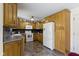 Open kitchen with plenty of cabinets, stainless appliances, tile backsplash, and lots of natural light at 10363 N County Road 950 E, Brownsburg, IN 46112