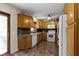 Efficient kitchen design with wood cabinets, stainless steel appliances, and a convenient side door at 10363 N County Road 950 E, Brownsburg, IN 46112