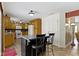 Well-lit kitchen with island seating, wooden cabinets, and easy access to other rooms at 10363 N County Road 950 E, Brownsburg, IN 46112