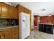 Kitchen area boasts plentiful cabinets, a stainless refrigerator, and view to the dining room at 10363 N County Road 950 E, Brownsburg, IN 46112