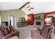 Comfortable living room featuring a brick fireplace, ceiling fan, and vaulted ceiling at 10363 N County Road 950 E, Brownsburg, IN 46112