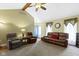 Open-concept living room with vaulted ceilings, ceiling fan and a view to the entryway at 10363 N County Road 950 E, Brownsburg, IN 46112