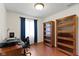 Bright office features rich wood floors, built-in shelving, and desk perfect for work from home at 10363 N County Road 950 E, Brownsburg, IN 46112