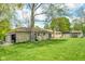 A sprawling backyard with lush green grass and a charming stone facade at 10827 Wonderland Dr, Indianapolis, IN 46239