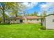 Expansive backyard featuring lush green grass and a detached storage shed at 10827 Wonderland Dr, Indianapolis, IN 46239