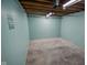 A smaller section of the basement features a light-blue wall and a motivational quote at 10827 Wonderland Dr, Indianapolis, IN 46239