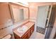 Bright bathroom features a sink with cabinet, mirror, and doorway to the side at 10827 Wonderland Dr, Indianapolis, IN 46239