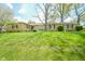 Charming single-story stone home with a well-manicured lawn and mature trees at 10827 Wonderland Dr, Indianapolis, IN 46239