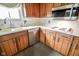 Kitchen with white countertops, stainless steel appliances, and wood cabinets at 10827 Wonderland Dr, Indianapolis, IN 46239